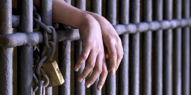 hands-prison-bars-lock